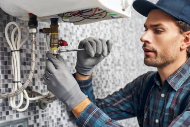 istockphoto-1129117534-612x612 Wrench always with you. Worker set up electric heating boiler at home. Close-up of young handyman